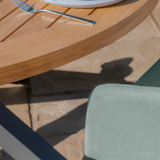 Maze - Jakarta Teak Round Dining Table
with 6 Outdoor Fabric Ambition Sage Green Dining Chairs - Blythe Living