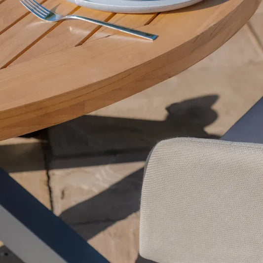 Maze - Jakarta Teak Round Dining Table
with 6 Outdoor Fabric Ambition Oatmeal Dining Chairs - Blythe Living